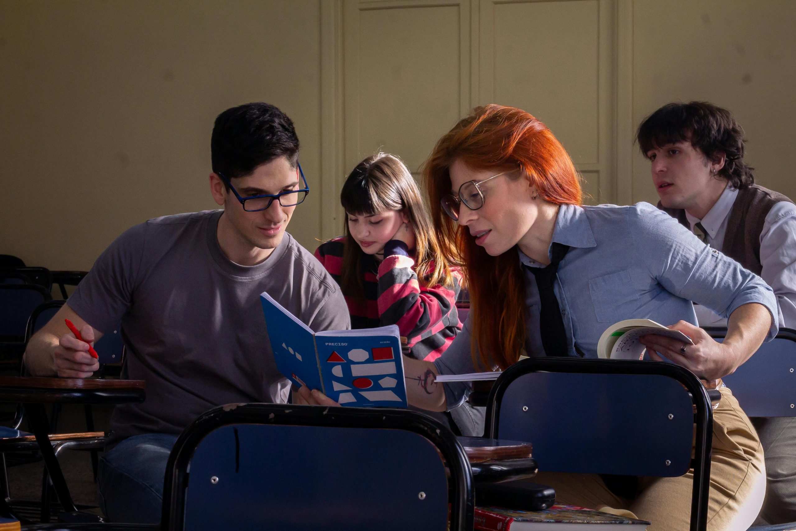 A group of students studying together in a classroom, illustrating collaborative learning.
